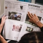 People reading a newspaper on a subway train, highlighting current events and diverse perspectives. — Importance of understan